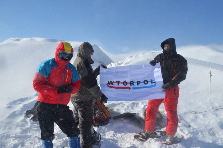 Niespodzianka dla sponsora – zdobywcy najwyżzego szczytu na Spitsbergenie prezentują flagę z logo skarżyskiej firmy.