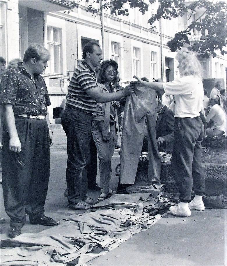 Uliczne stoisko odzieżowe na deptaku al. Wojska Polskiego wczesną jesienią 1990 roku - przymierzanie spodni