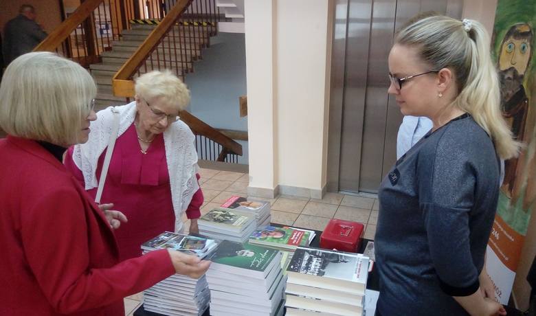 Teresa Gładysz (druga z lewej) ogląda książki księdza Tadeusza Isakowicza-Zaleskiego