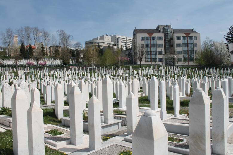 Tuż obok jest inny cmentarz, który podczas oblężenia wyrósł na małym stadionie olimpijskim. W tle zabudowania szpitala Koševo, do którego trafiali ranni.