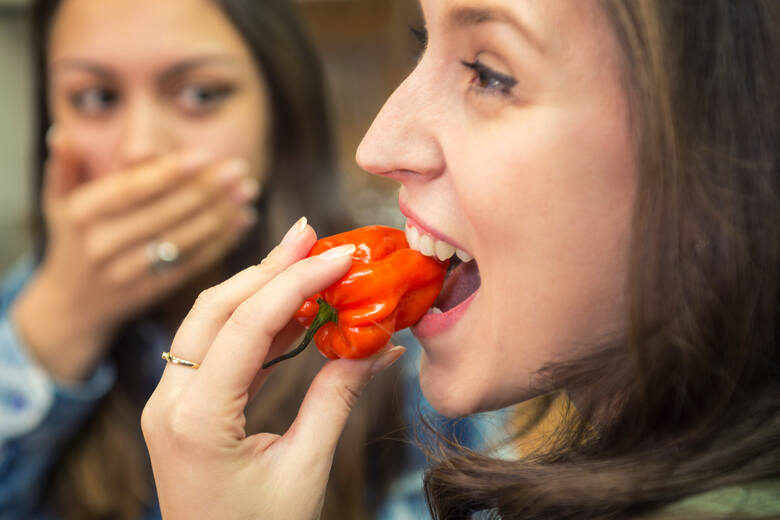 Kobieta je papryczkę chili i szokuje koleżankę