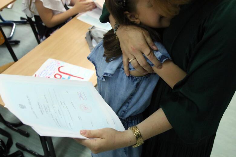 Dziewczynka przytula się do nauczycielki.