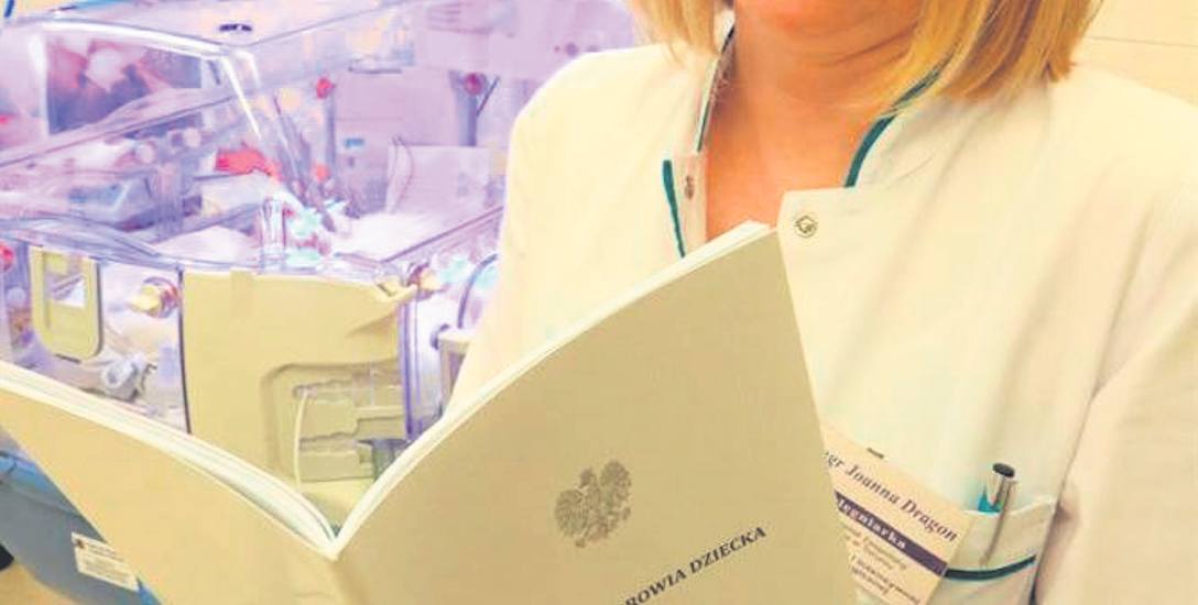 Joanna Dragon pracująca w szpitalu na Bielanach ogląda nową książeczkę zdrowia dziecka.