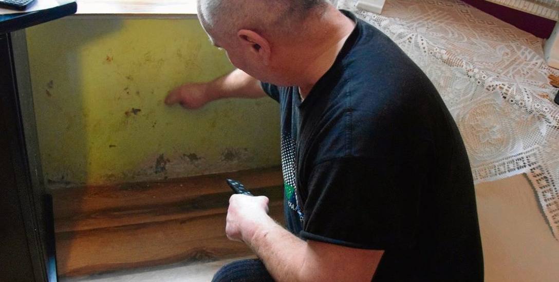 Jeden z mieszkańców budynku przy ul. Długiej, pan Zbigniew, pokazuje wilgoć, która miała zacząć się pojawiać w jego mieszkaniu po rozpoczęciu remontu