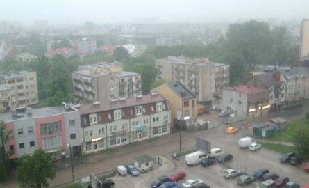 Ulewa zalała ulicę Nowy Świat w Kielcach, samochody brną w wodzie.