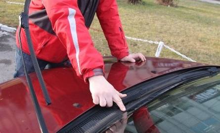 Właściciel forda focusa, Zbigniew Kołacz pokazuje uszkodzenie na szybie samochodu.