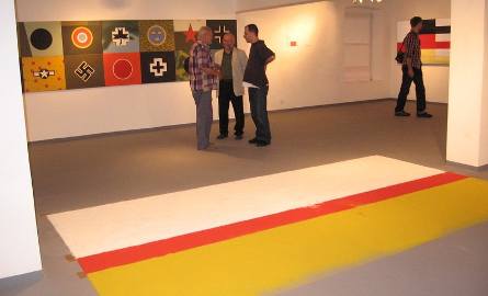 Niezwykle ciekawą kompozycją jest wykonana na podłodze instalacja biało - czerwono - żółta Jerzego Kaliny "Flago wyprowadź się z równowagi”